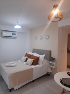 a bedroom with a large bed and a table at Legui Suites in Salta
