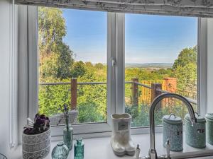 a kitchen counter with a view of a window at Hillside Hideaway in Flaxley