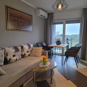 a living room with a couch and a table at Apartment Mirella in Umag