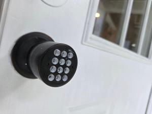 a black door knob on a white door with a window at Penthouse Suite - Chez Mango Villa in Olveston +12 photos