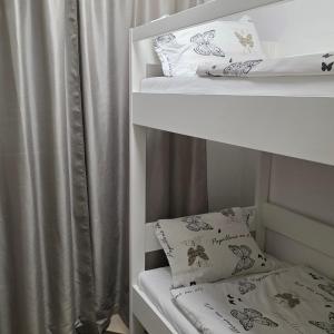 a bunk bed with two pillows and a curtain at Apartment Mirella in Umag