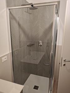 a shower with a glass door in a bathroom at Lacasabianca guest house saronno in Saronno +22 photos