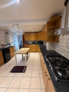 a kitchen with wooden cabinets and a wooden table at Near city centre, Derby train station and royal Derby hospital in Derby +46 photos