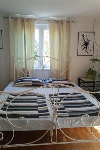 a bedroom with a large bed with a metal frame at Apartments with parking space Vodice - 927 in Vodice