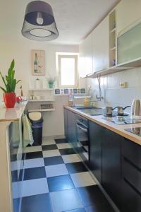 a kitchen with a black and white checkered floor at Apartments with parking space Vodice - 927 in Vodice