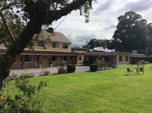 a house with a green yard with a table and chairs at The Gardens guest accommodation in Killarney +32 photos