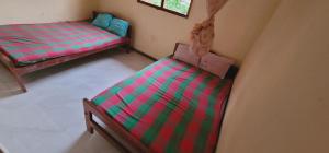an overhead view of two beds in a room at Lavanya Holiday Resort Kataragama in Kataragama
