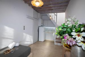 a living room with a large vase with flowers in it at Mykonos Town Aura Panorama with Private Terrace in Megali Ammos