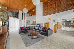 a living room with a couch and a table at Yulunga 20 in Mooloolaba