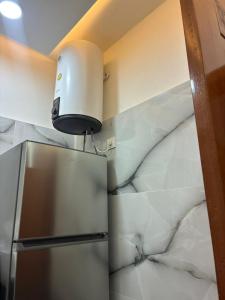 a kitchen with a refrigerator and a light on the wall at vk-appart in Maianga +9 photos