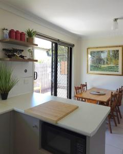 a kitchen and dining room with a table and a counter top at 2-Bedroom Townhouse Next to the Hospital in Bendigo