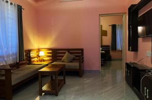 a bedroom with a bed and a table and a mirror at Aikara cottages in Vagamon