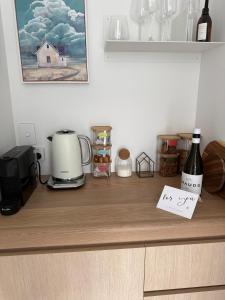 a counter top with a coffee maker and a note at McNeil Luxury Studio in Wanaka
