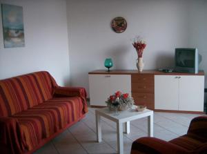 a living room with a couch and a table at Appartamenti Maria Grazia in Dongo