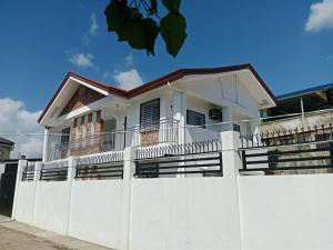 a white fence in front of a house at Jannish Transient House in Masbate