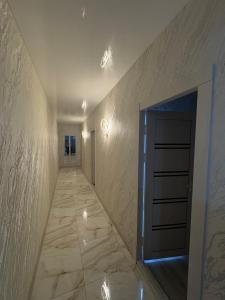 an empty hallway with a door and a tile floor at Old Bazar in Kogon +1 photo