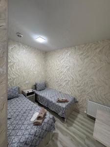 a bedroom with two beds with shoes on them at Old Bazar in Kogon