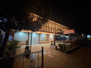 a building with lights on it at night at Old Bazar in Kogon