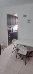a kitchen with a table and chairs in a room at Casa condomínio in Maceió