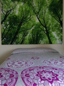 a bedroom with a bed with a painting on the wall at VENECIA APARTMENT, Excellent Location in Tepic