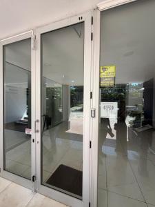 a glass door in a building with a sign on it at Torre Aymara 8C in Posadas +13 photos