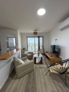 a living room with a couch and a table at Torre Aymara 8C in Posadas