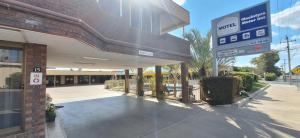 a building with a sign in front of it at Macintyre Motor Inn in Goondiwindi