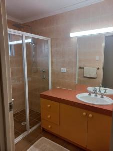 a bathroom with a sink and a shower at Peaceful and private two bedroom unit in Alice Springs +27 photos