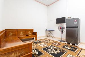 a kitchen with a refrigerator and a floor with a rug at Griyaponcowolo Syariah Full Furnished Family Home in Central Jogja in Yogyakarta