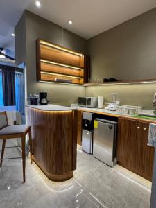 a kitchen with wooden cabinets and a stainless steel appliance at Torre Marsai By MrW in Higuera Blanca