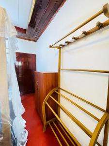 a bedroom with two bunk beds and a curtain at Madu Villa in Weligama