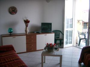 a living room with a couch and a table with a tv at Appartamenti Maria Grazia in Dongo +8 photos