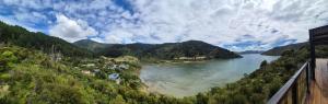a view of a body of water with mountains at Bayheights in Picton