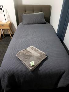 a bed with a blanket on top of it at The Cri on Main in Grenfell