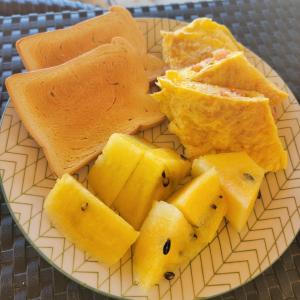 a plate of food with cheese and pineapple on it at Island Crib in El Nido