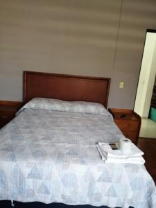 a bedroom with a bed with a wooden head board at Ciudad del Valle Departamento C in Tepic