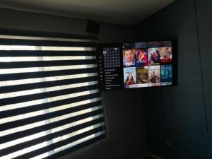 a window with a flag and a tv on a wall at Ciudad del Valle Departamento C in Tepic