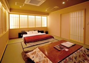 a hotel room with two beds and a table at PrincessPrincessAzumino in Azumino