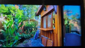 a window view of a house with a garden at Piccolo Casa de playa La caleta in Mar de Cobo +9 photos