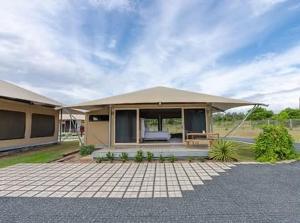 a house with a tent on top of it at Crowdy Bay Eco Resort in Harrington