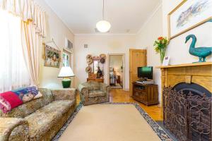 a living room with a couch and a fireplace at Winery Cottage in Tanunda