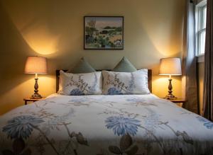 a bedroom with a large bed with two lamps at Berkshire House Stay in Lee