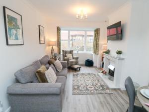 a living room with a couch and a fireplace at The Old Chapel in Scarborough