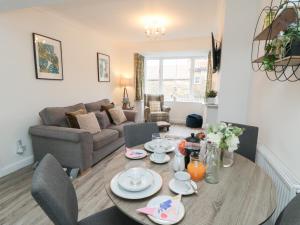 a living room with a table and a couch at The Old Chapel in Scarborough