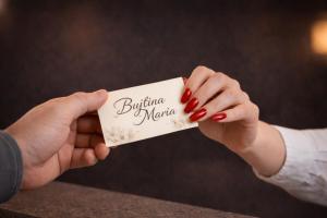 a woman holding a piece of paper with the words buffalo nation at Bujtina Maria in Gjirokastër