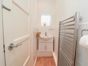 a white bathroom with a sink and a mirror at The Old Chapel in Scarborough +23 photos