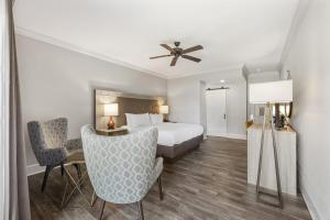 a hotel room with a bed and a desk and chairs at The Ridges Resort on Lake Chatuge in Young Harris +110 photos