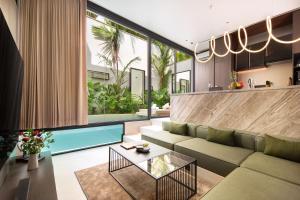 a living room with a couch and a table at Echo Beach Villas 6 in Canggu