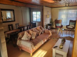 a living room with a couch and a table at Los Camperos AR in Temuco