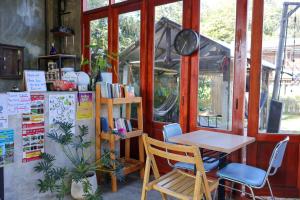 a table and chairs in a room with a table at Moon Garden Hostel in Pai